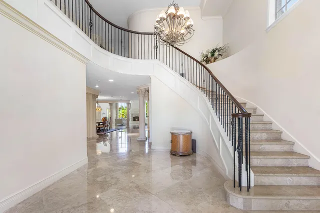 a bathroom with a tub and large windows