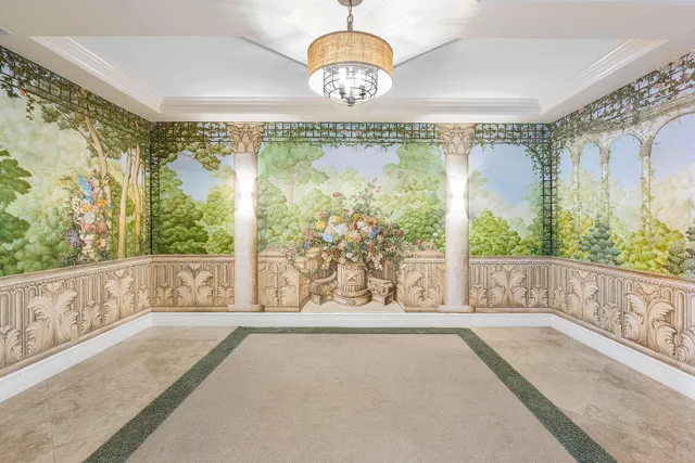 a living room with kitchen island furniture and a chandelier