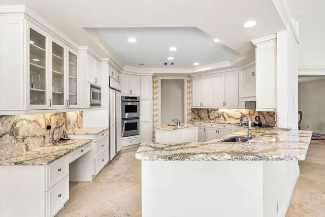 a spacious bathroom with a granite countertop tub sink and mirror