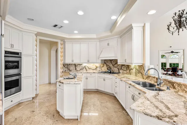 a bathroom with a granite countertop sink and a bathtub