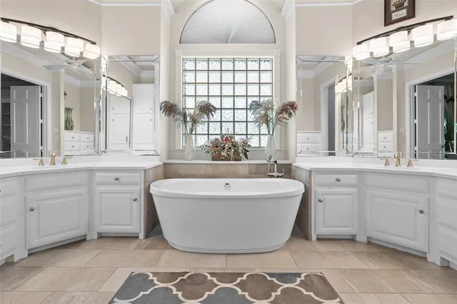 a spacious bathroom with a large tub sink and mirror