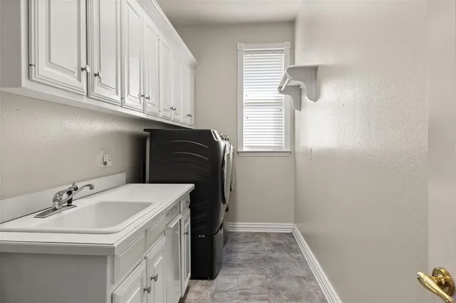 a bathroom with a sink and cabinets