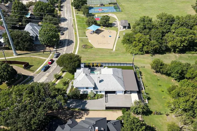 an aerial view of a house with a yard swimming pool and outdoor seating