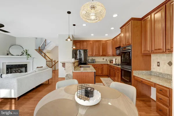 a living room with stainless steel appliances kitchen island granite countertop furniture and a kitchen view