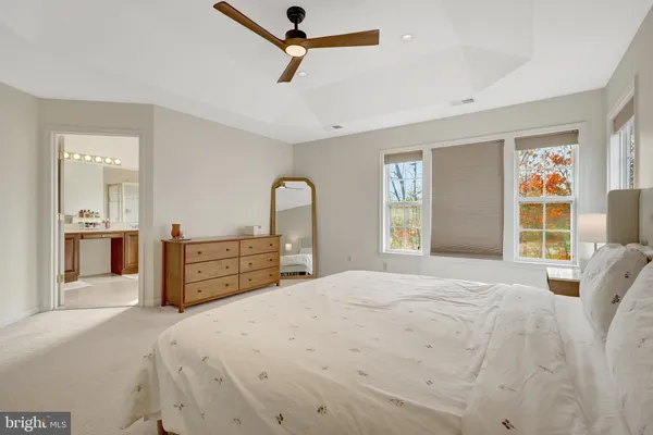 a bedroom with a bed painted wall painting and a window