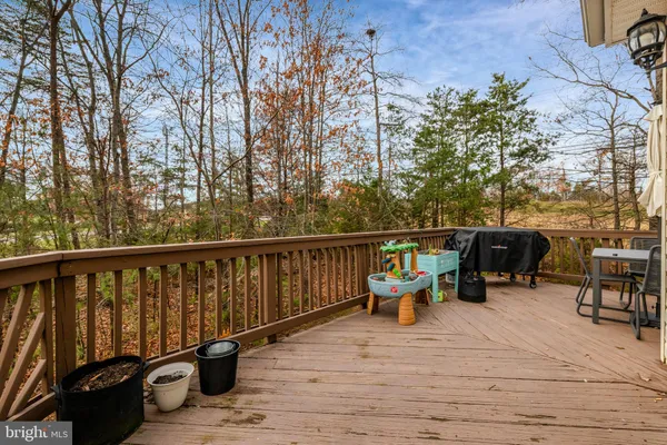 a view of a porch with wooden floor and chairs