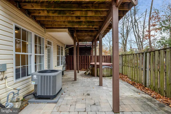 a view of a porch with a table chairs and a yard