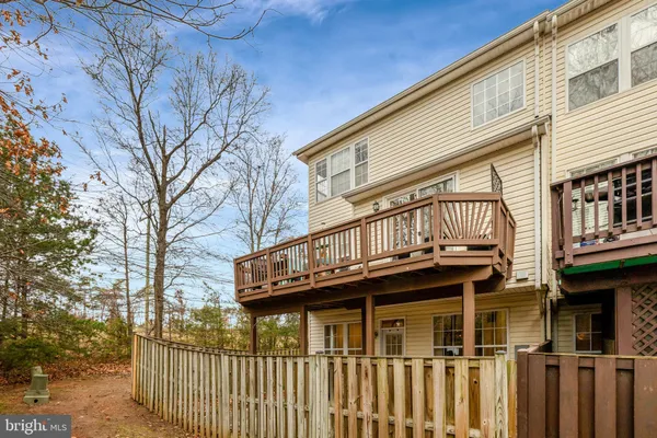 a view of a house with wooden fence
