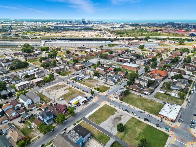 an aerial view of residential houses with city view
