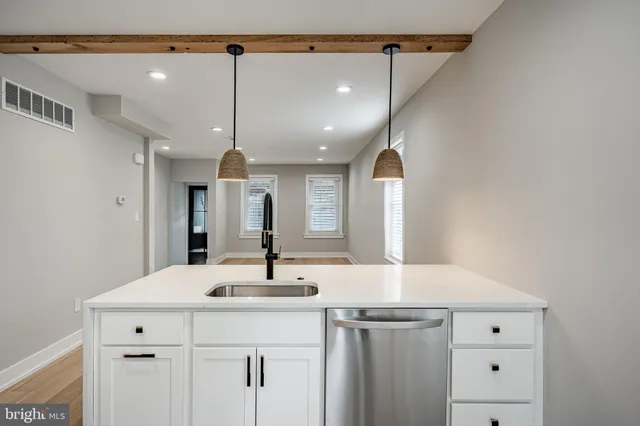 a bathroom with a sink vanity and a mirror