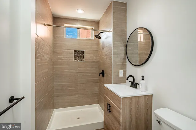 a bathroom with a sink a mirror and a shower