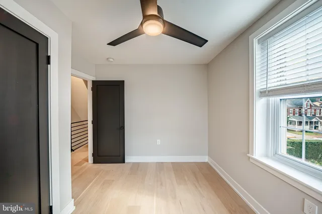 an empty room with windows and entrance