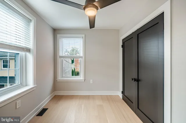 wooden floor in an empty room with a window