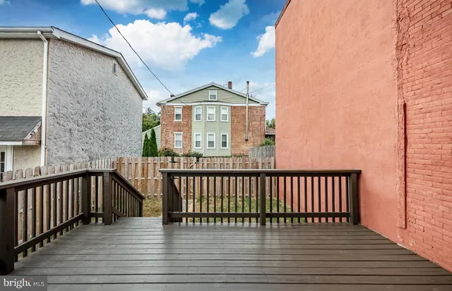 a view of a balcony with wooden floor