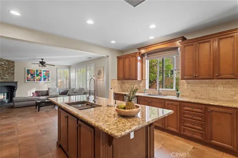 a kitchen with granite countertop a sink and a counter top space