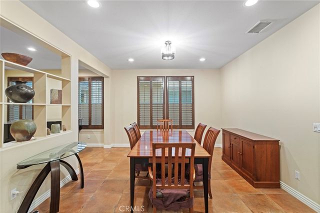 a view of a dining room with furniture and a potted plant