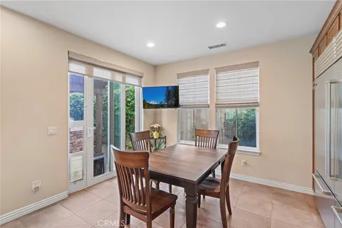 a dining room with furniture window and wooden floor