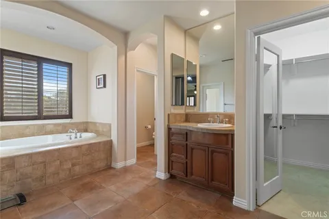 a spacious bathroom with a shower sink and mirror