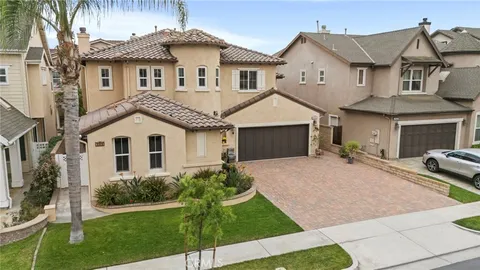 an aerial view of a house with swimming pool garden and patio