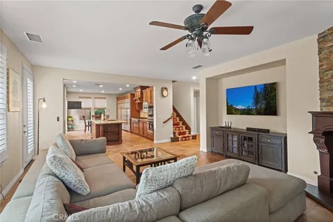 a living room with furniture kitchen view and a window
