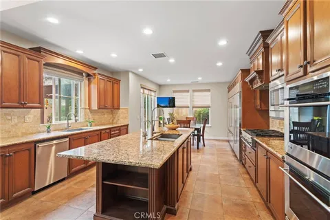 a kitchen with counter top space a sink appliances and cabinets