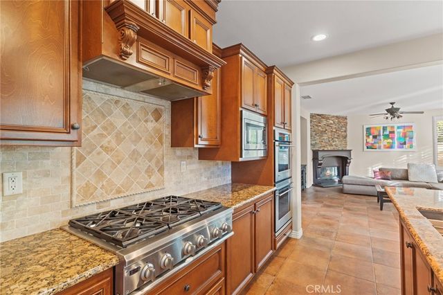 a kitchen with stainless steel appliances granite countertop a stove and a refrigerator