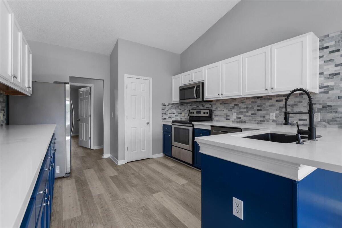 427 Triton Street Crestview, FL 32536 - Photo 12 of 43 a kitchen with a sink appliances and cabinets