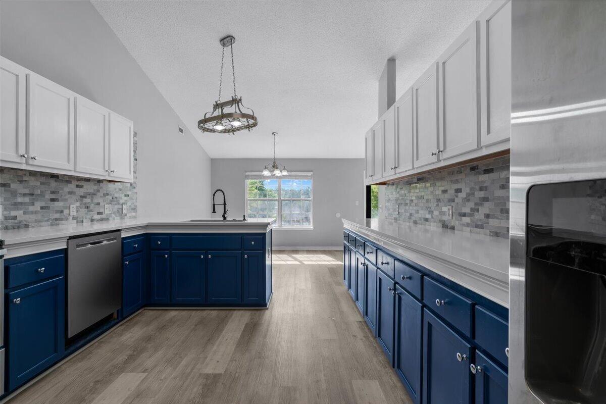 427 Triton Street Crestview, FL 32536 - Photo 13 of 43 a kitchen with stainless steel appliances granite countertop a sink stove and cabinets