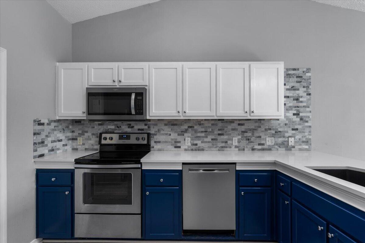 427 Triton Street Crestview, FL 32536 - Photo 14 of 43 a kitchen with stainless steel appliances a stove a microwave and sink