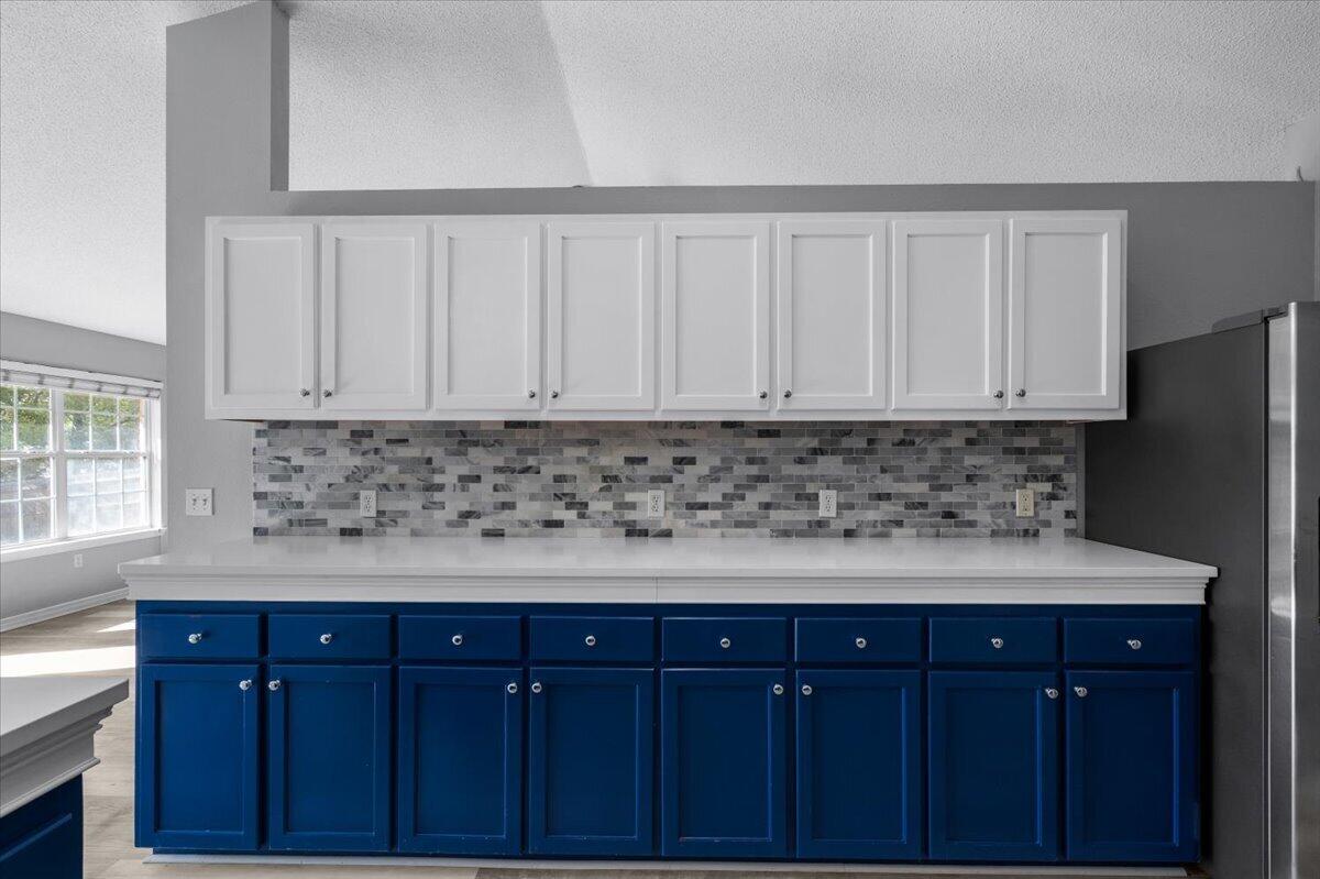 427 Triton Street Crestview, FL 32536 - Photo 15 of 43 a kitchen with granite countertop white cabinets and sink