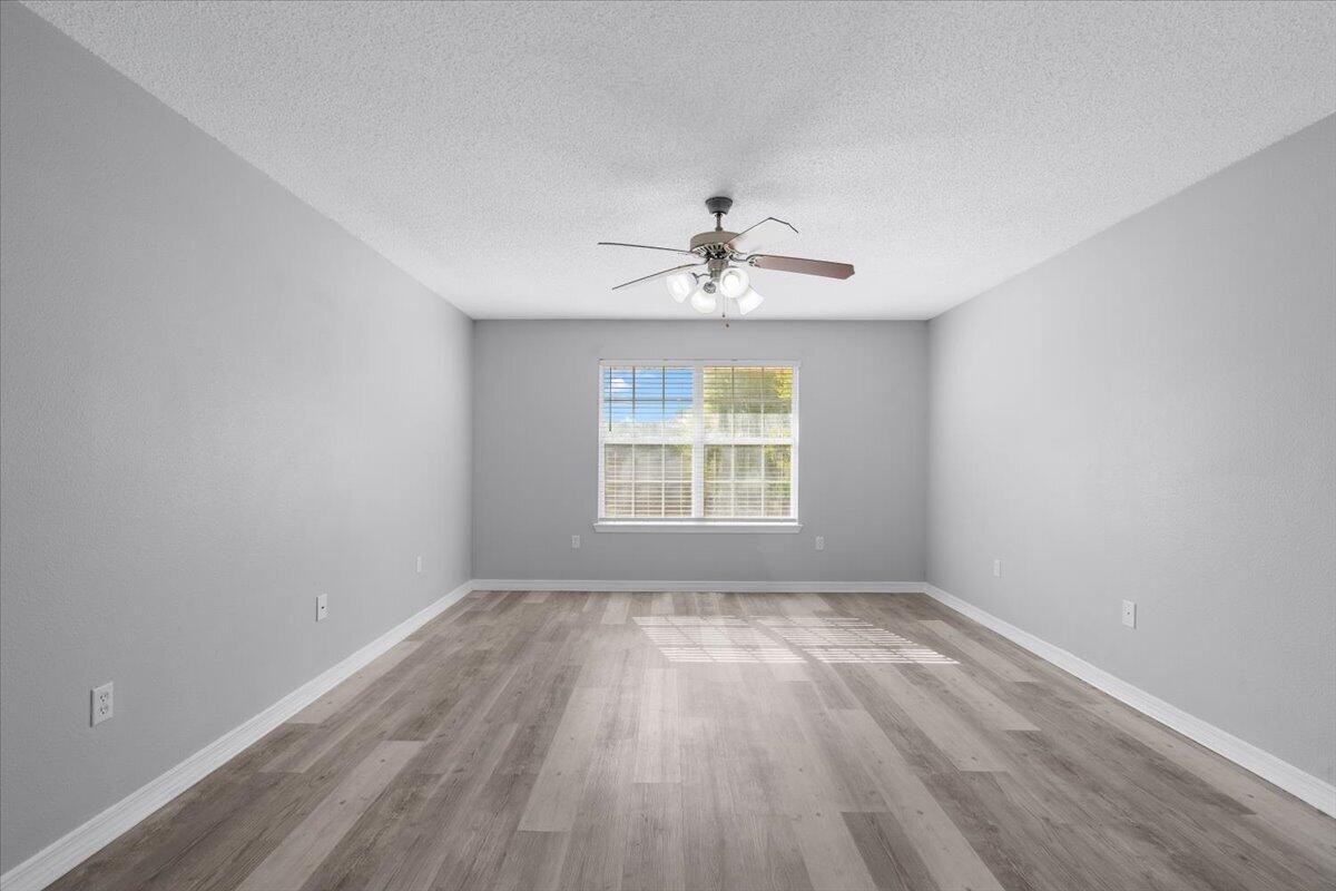 427 Triton Street Crestview, FL 32536 - Photo 19 of 43 wooden floor in an empty room with a window