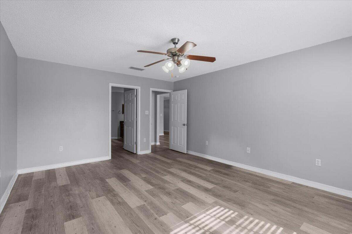 427 Triton Street Crestview, FL 32536 - Photo 20 of 43 a view of a room with a ceiling fan and hardwood floor