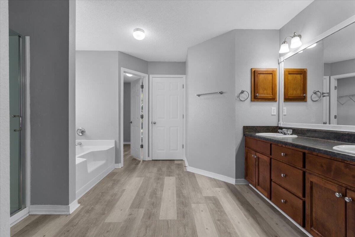 427 Triton Street Crestview, FL 32536 - Photo 21 of 43 a spacious bathroom with a vanity a sink a mirror and a bathtub