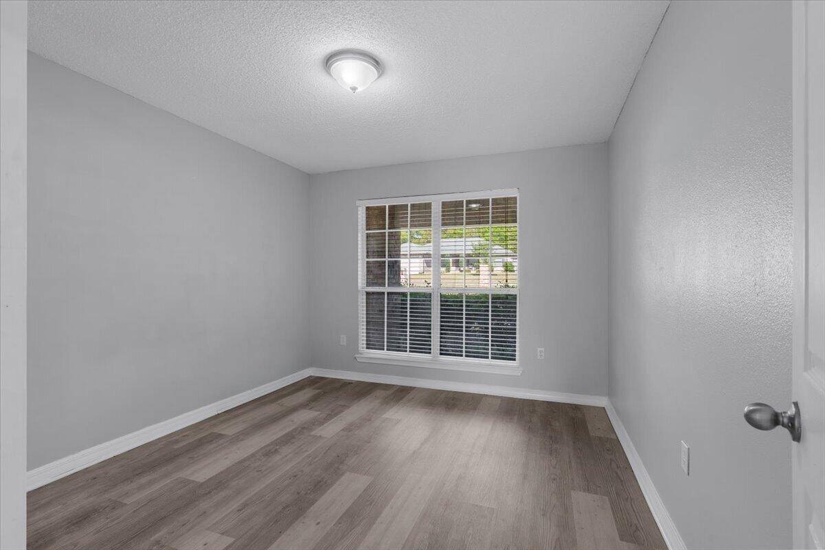 427 Triton Street Crestview, FL 32536 - Photo 30 of 43 an empty room with wooden floor and windows