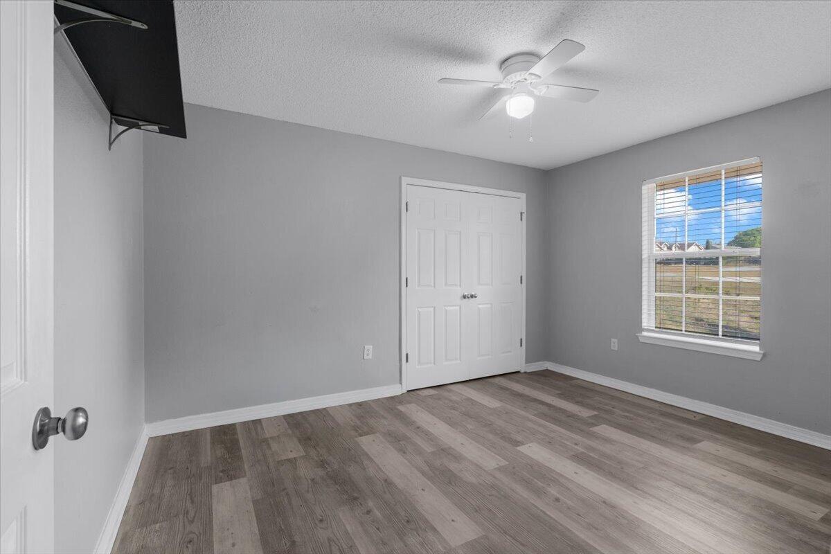 427 Triton Street Crestview, FL 32536 - Photo 32 of 43 wooden floor in an empty room with a window