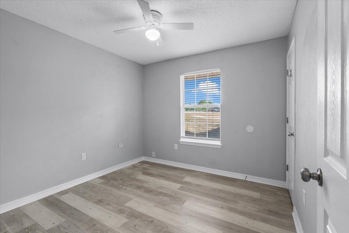 427 Triton Street Crestview, FL 32536 - Photo 33 of 43 wooden floor in an empty room with a window
