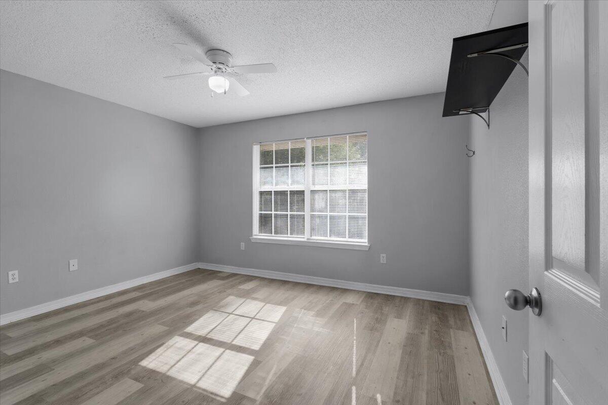 427 Triton Street Crestview, FL 32536 - Photo 34 of 43 an empty room with wooden floor and windows