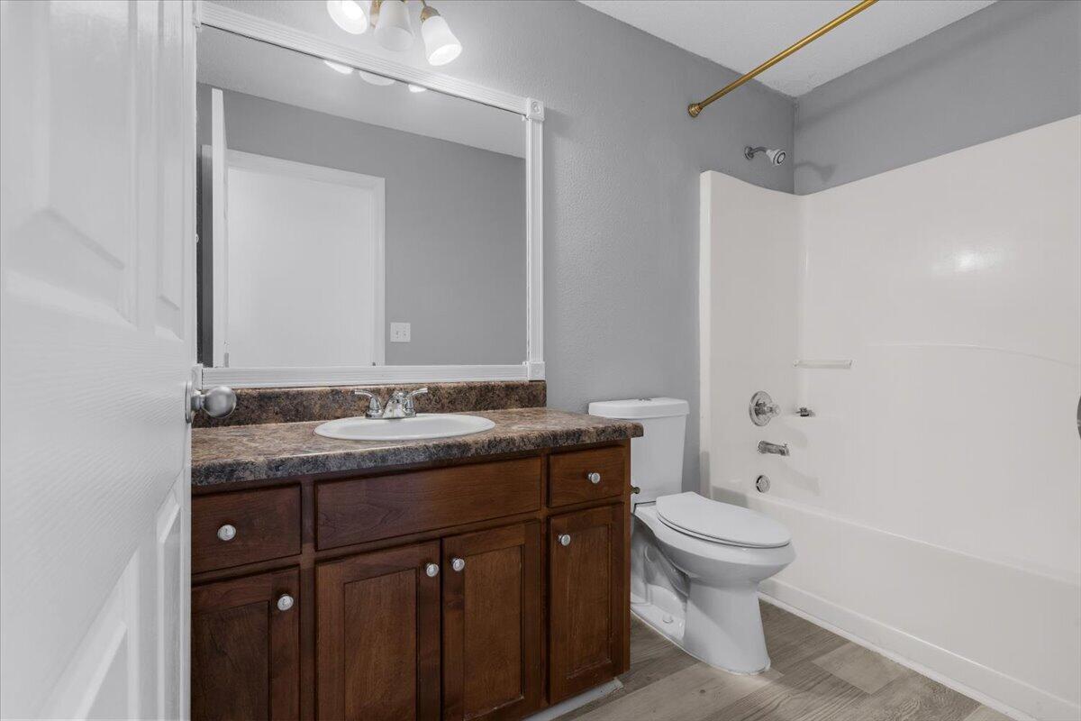 427 Triton Street Crestview, FL 32536 - Photo 35 of 43 a bathroom with a granite countertop sink a toilet and a mirror