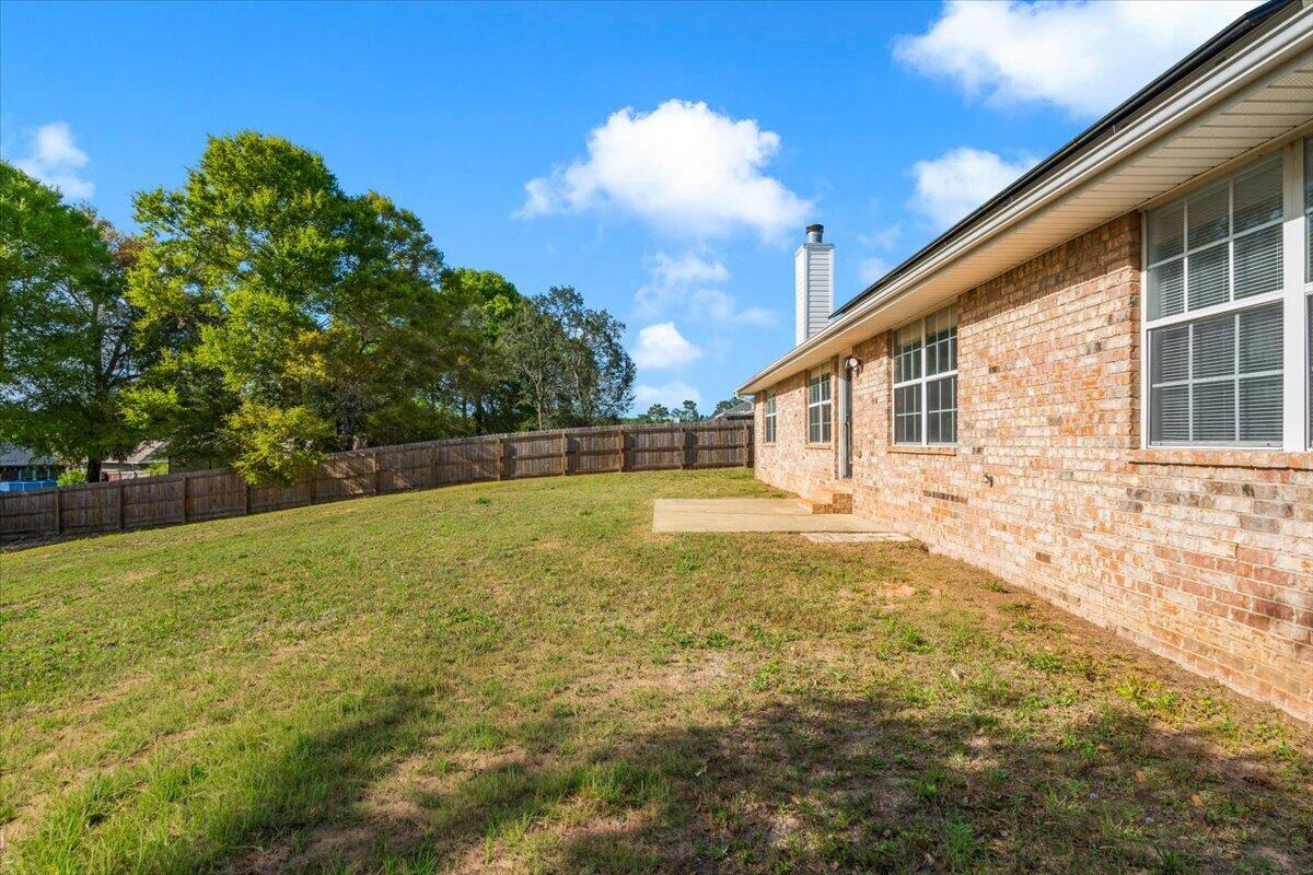 427 Triton Street Crestview, FL 32536 - Photo 38 of 43 a backyard of a house with lots of green space
