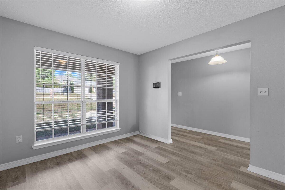 427 Triton Street Crestview, FL 32536 - Photo 5 of 43 a view of empty room with wooden floor and fan