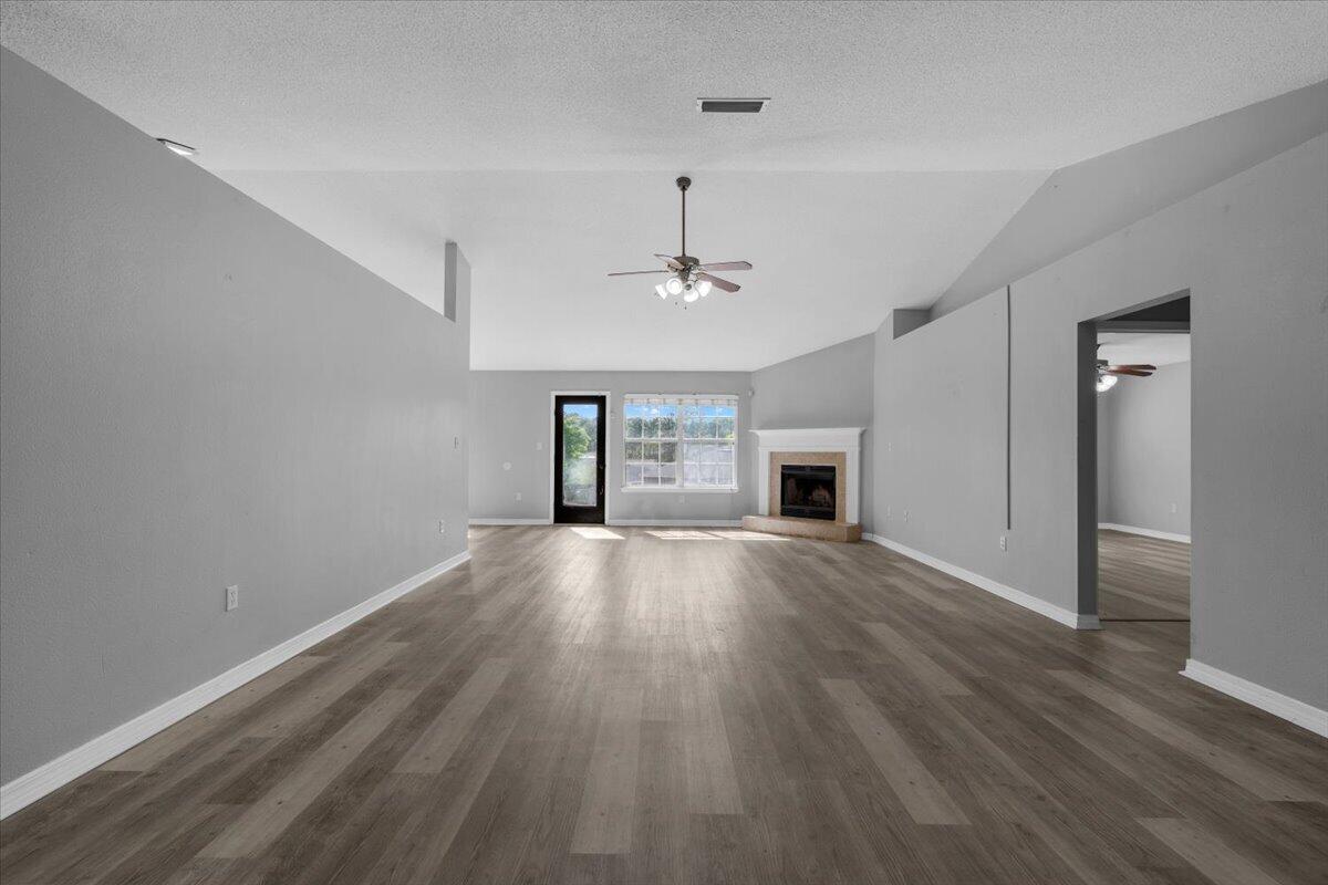 427 Triton Street Crestview, FL 32536 - Photo 6 of 43 an empty room with wooden floor and windows