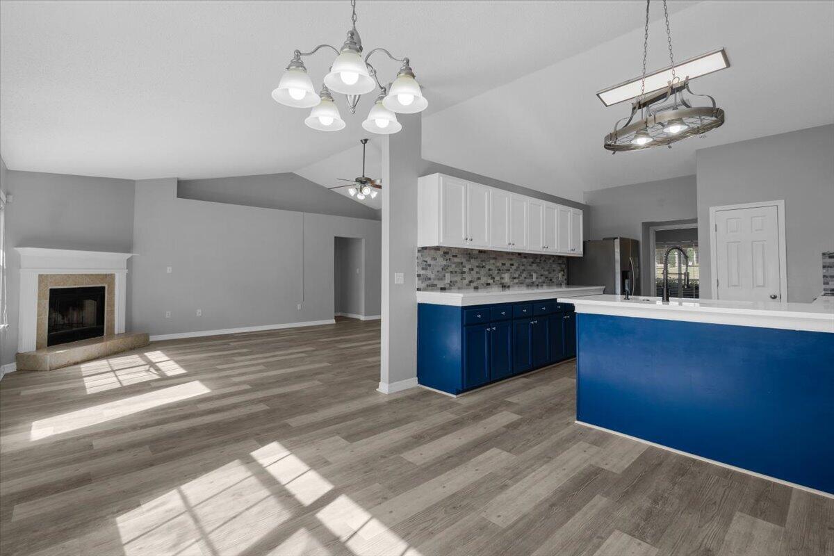 427 Triton Street Crestview, FL 32536 - Photo 10 of 43 a kitchen with a refrigerator and chandelier