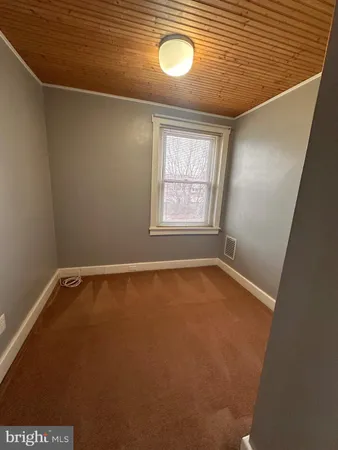 a view of a room with window and wooden floor
