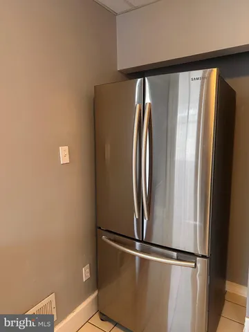 a view of a refrigerator in a kitchen