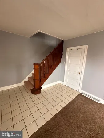 a view of an empty room and staircase