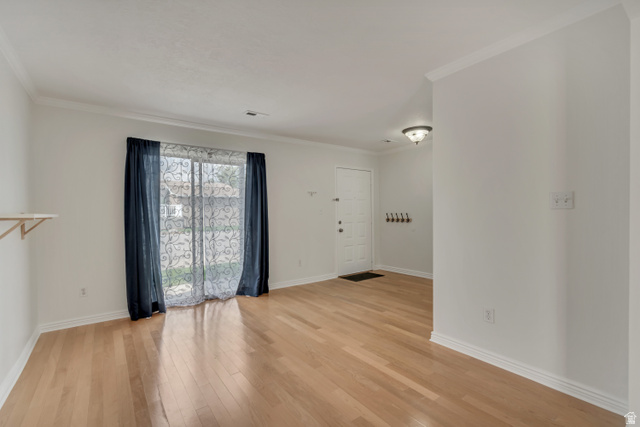 653 South 500 West, Unit 1 Provo, UT 84601 - Photo 15 of 17 Open concept room featuring wood-finish flooring, white baseboards, and crown molding