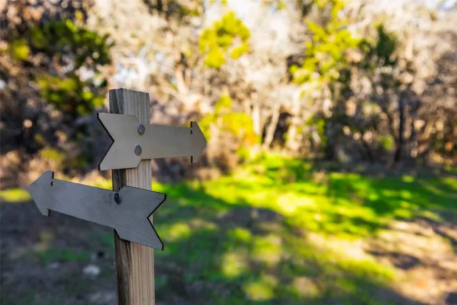 a view of a yard with wooden fence