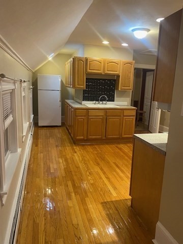 211 Buffinton Street, Unit 3 Fall River, MA 02721 - Photo 2 of 9 a view of a kitchen with a sink a microwave and cabinets