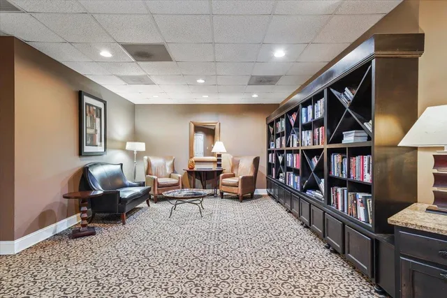 a living room with lots of furniture and a book shelf
