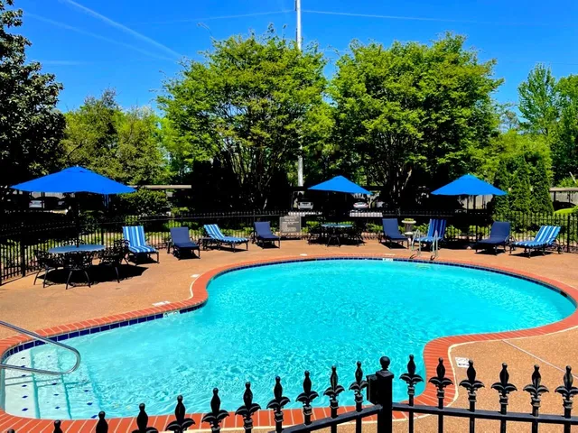 a view of a patio with a table chairs and a glass door